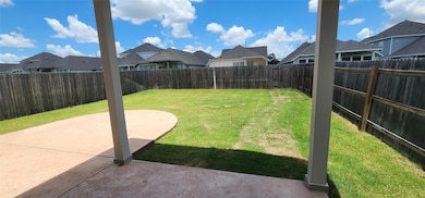 Fenced backyard featuring a residential view and 
