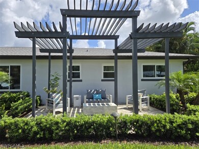 Rear view of house featuring a pergola, an outdoor