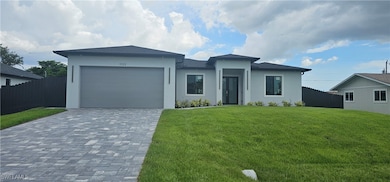 Prairie-style home featuring decorative driveway,