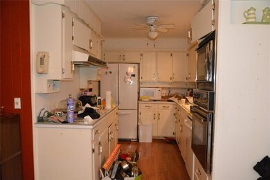 Kitchen featuring black appliances, ceiling fan, a