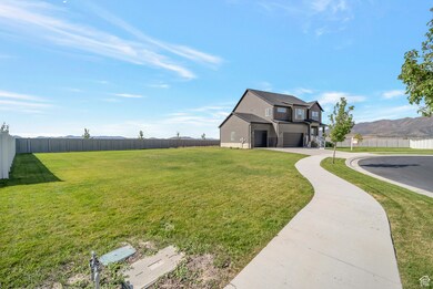 View of home's exterior with a mountain view, a garage, driveway, and covered porch