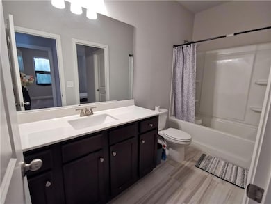 Bathroom featuring vanity and shower / bath combo with shower curtain