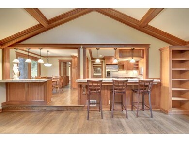 The kitchen is open to an adjacent large hearth ro