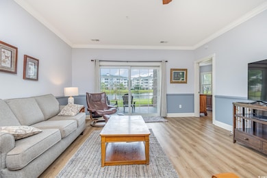 Living room with ornamental molding, a wealth of n