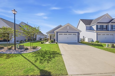 Craftsman inspired home featuring a front lawn, driveway, and a garage