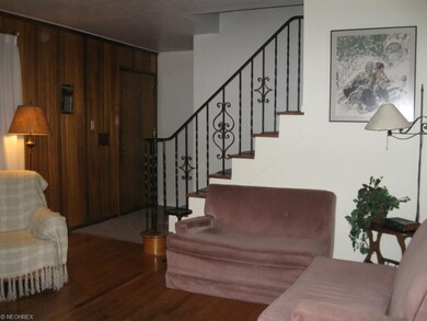 Section of living room showing staircase to 2nd fl