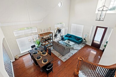 Living room featuring high vaulted ceiling, an inv