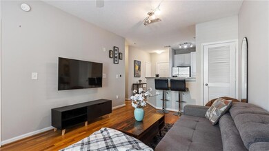 Living room with baseboards, wood finished floors,