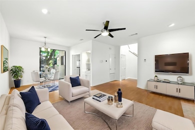 Living area featuring ceiling fan with notable ch