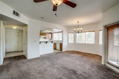 The living room features ceiling fan and entry to