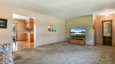 LIVING ROOM WITH VIEW INTO KITCHEN AND DINING AREA