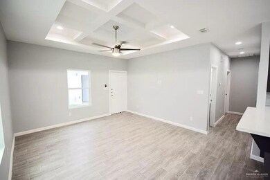 Spare room with baseboards, wood finished floors, and visible vents