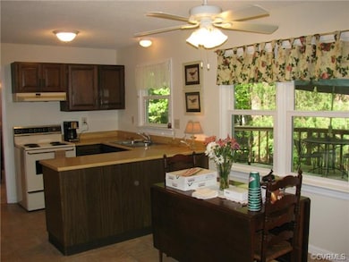 Kitchen with adjoining eat in area.