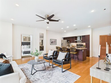 Living area featuring a ceiling fan, light wood-s