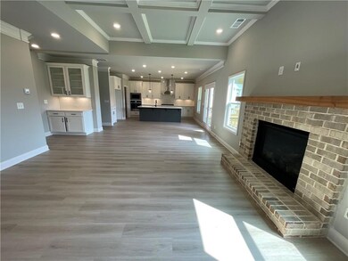 Unfurnished living room with coffered ceiling, bea