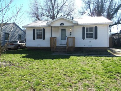 Ranch-style house featuring a front lawn