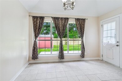 Ample dining space off kitchen overlooking patio