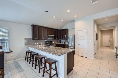 Kitchen featuring light tile patterned floors, st