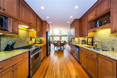 Stainless steel appliances, granite, tile backspla