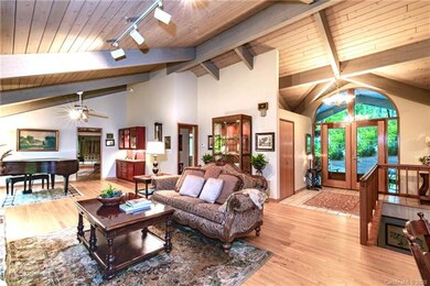 Great room with vaulted wood ceilings and beams an