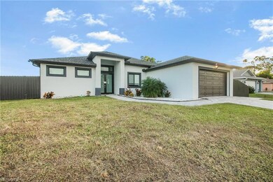 Prairie-style home with stucco siding, an attached garage, driveway, and a shingled roof