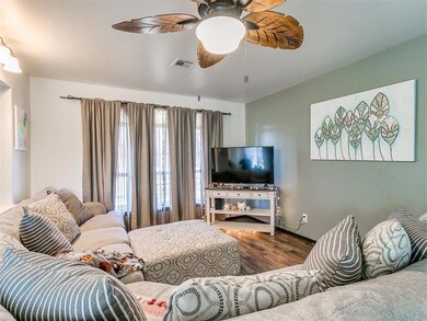 Living room with hardwood / wood-style flooring an