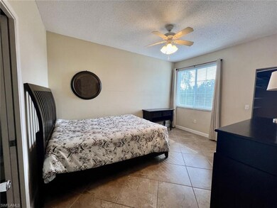Bedroom featuring baseboards, a ceiling fan, tile 