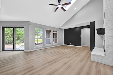 Spacious living room featuring soaring vaulted cei