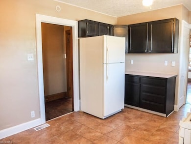 Kitchen has ceramic tile flooring.