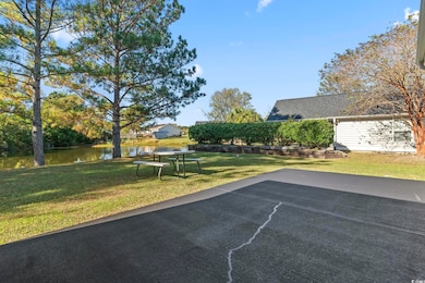 View of grassy yard with a water view