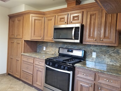 Lots of cabinets complete this well equipped kitchen. Stainless steel gas range w/microwave.