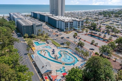 Drone / aerial view of a pool and a nearby body of water
