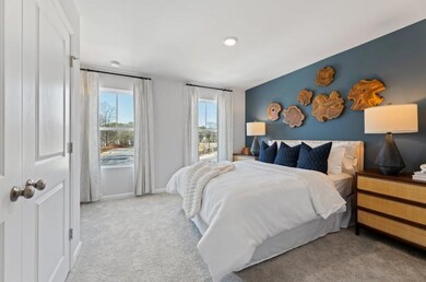 Carpeted bedroom featuring baseboards