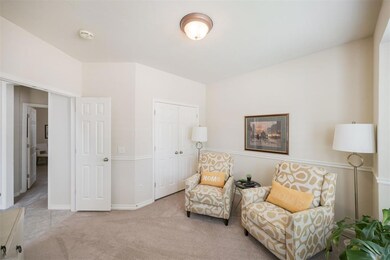 Sitting room featuring carpet flooring and baseboards