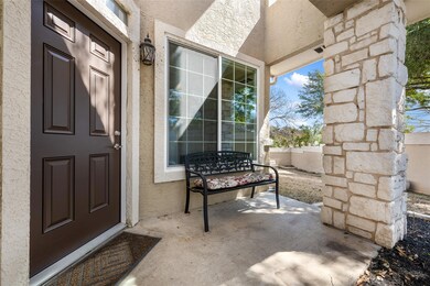 Property entrance with a patio and stucco siding