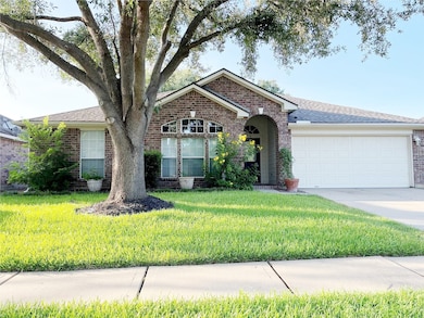 Charming front view with lush, mature trees enhanc
