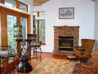 Cozy Den with stone fireplace and  french doors to