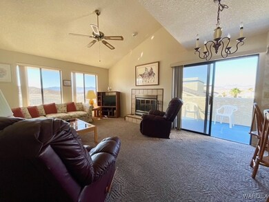 Living room featuring carpet floors, a tiled firep