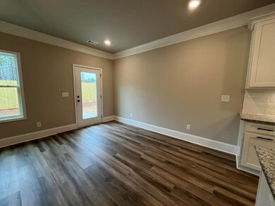 Dining area with crown molding, baseboards, recessed lighting, and dark wood-style floors