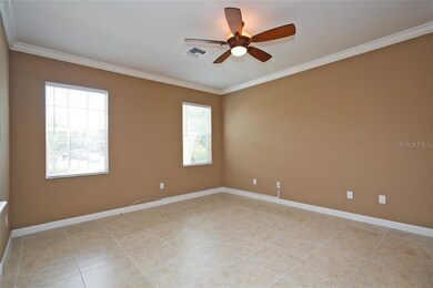 Great room w/oversized tile floors and crown moldi