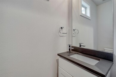 Half bathroom featuring vanity and toilet