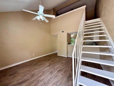 Stairs featuring a ceiling fan, wood finished flo