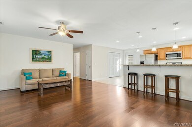 Living room featuring ceiling fan and engineered w
