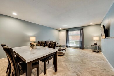 Dining space with light parquet flooring