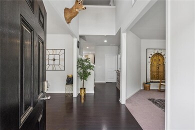 Foyer entrance with wood finished floors and baseboards
