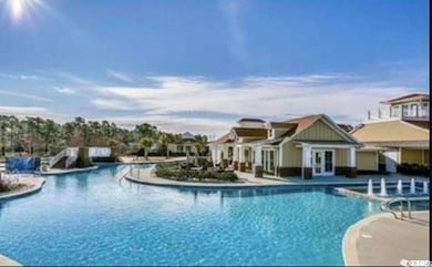 Community pool with a patio and french doors