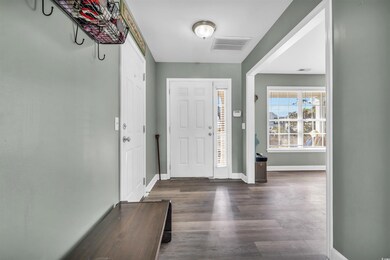 Foyer entrance featuring dark hardwood / wood-styl