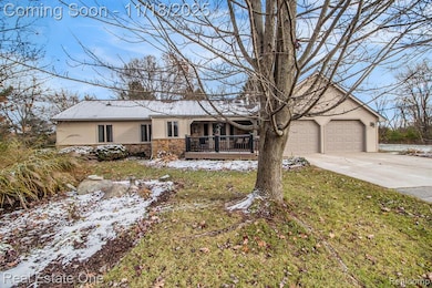 Ranch-style home, driveway, stone siding and attached garage