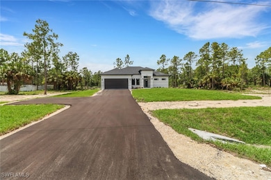 View of front of house with paved driveway