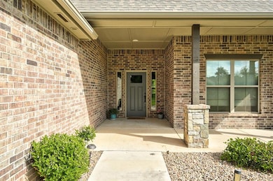 Entrance to property with roof with shingles and b